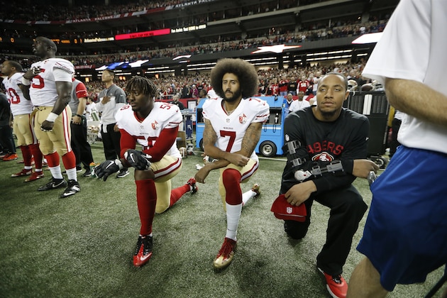 San Francisco 49ers quarterback Colin Kaepernick (7) and San Francisco 49ers outside linebacker Eli Harold (58) kneel during the playing of the National anthem before the first half of an NFL football game between the Atlanta Falcons and the San Francisco 49ers, Sunday, Dec. 18, 2016, in Atlanta. (AP Photo/John Bazemore)
