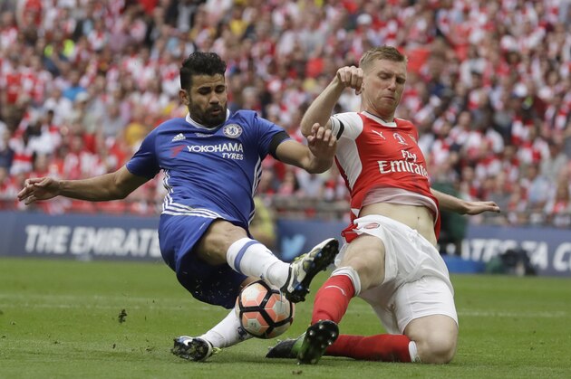 Chelsea's Diego Costa, left, challenges for the ball with Arsenal's Per Mertesacker during the English FA Cup final soccer match between Arsenal and Chelsea at the Wembley stadium in London, Saturday, May 27, 2017. (AP Photo/Matt Dunham)