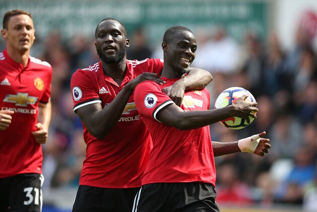 SWANSEA, WALES - AUGUST 19: Eric Bailly of Manchester United celebrates after he scores a goal to make it 0-1 with Romelu Lukaku of Manchester United during the Premier League match between Swansea City and Manchester United at Liberty Stadium on August 19, 2017 in Swansea, Wales. (Photo by Catherine Ivill - AMA/Getty Images)