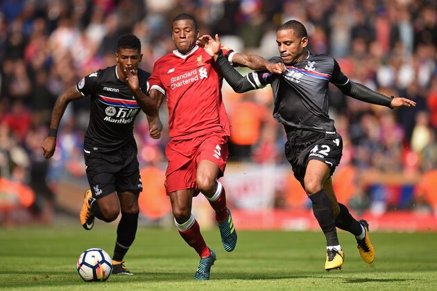 Liverpool's Dutch midfielder Georginio Wijnaldum (C) vies with Crystal Palace's English midfielder Jason Puncheon (R) and Crystal Palace's Dutch defender Patrick van Aanholt (L) during the English Premier League football match between Liverpool and Crystal Palace at Anfield in Liverpool, north west England on August 19, 2017. / AFP PHOTO / Oli SCARFF / RESTRICTED TO EDITORIAL USE. No use with unauthorized audio, video, data, fixture lists, club/league logos or 'live' services. Online in-match use limited to 75 images, no video emulation. No use in betting, games or single club/league/player publications.  /         (Photo credit should read OLI SCARFF/AFP/Getty Images)
