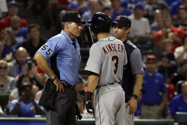 Home plate umpire Angel Hernandez, listens to Detroit Tigers' Ian Kinsler (3) as manager Brad Ausmus stands by in the fifth inning of a baseball game, Monday, Aug. 14, 2017, in Arlington, Texas. Kinsler and Ausmus were ejected by Hernandez during the argument. (AP Photo/Tony Gutierrez)