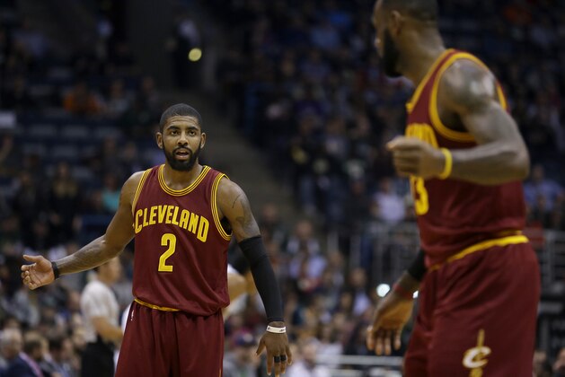 Cleveland Cavaliers' Kyrie Irving (2) talks with LeBron James during an NBA basketball game against the Milwaukee Bucks Tuesday, Nov. 29, 2016, in Milwaukee. (AP Photo/Aaron Gash)