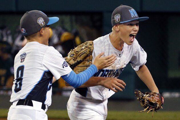 Walla Walla, Wash., pitcher Andrew Hill, right, begins to celebrate with Hayden Lomeli (8) after getting the final out of a 4-3 win over Sioux Falls, S.D., in an elimination baseball game in U.S. play at the Little League World Series in South Williamsport, Pa., Saturday, Aug. 19, 2017. (AP Photo/Gene J. Puskar)
