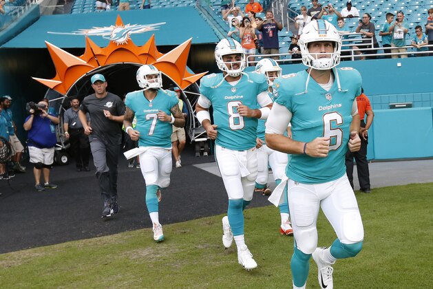 Miami Dolphins quarterback Jay Cutler (6) enters the field followed by quarterbacks Matt Moore (8) and Brandon Doughty (7), before an NFL preseason football game against the Baltimore Ravens, Thursday, Aug. 17, 2017, in Miami Gardens, Fla. (AP Photo/Wilfredo Lee)