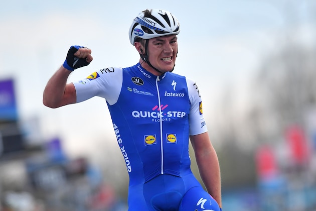 Belgian Yves Lampaert of Quick-Step Floors celebrates as he crosses the finish line to win the 72nd edition of the 'Dwars Door Vlaanderen' cycling race, 203,1km from Roeselare to Waregem, on March 22, 2017. / AFP PHOTO / Belga / DAVID STOCKMAN / Belgium OUT        (Photo credit should read DAVID STOCKMAN/AFP/Getty Images)