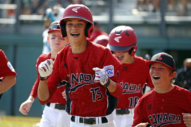 White Rock, British Columbia's Reid Hefflick (15) celebrates with teammates as he returns to the dugout after hitting a three-run home run off Maracaibo, Venezuela pitcher Dario Cardozo (16) in the first inning of an International pool play baseball game at the Little League World Series tournament in South Williamsport, Pa., Sunday, Aug. 20, 2017. Canada won 7-3. (AP Photo/Gene J. Puskar)