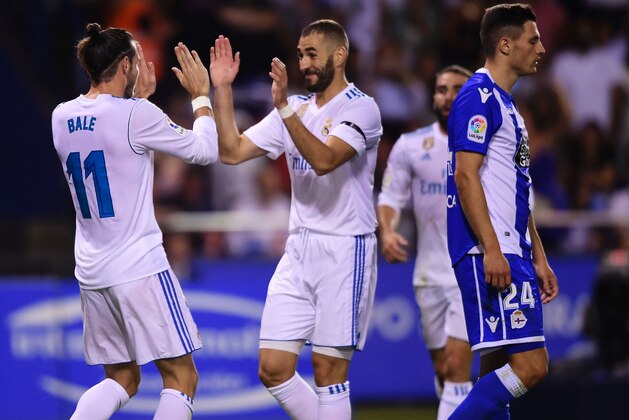 Real Madrid's Welsh forward Gareth Bale (L) celebrates with teammate French forward Karim Benzema after scoring a goal during the Spanish league footbal match RC Deportivo de la Coruna vs Real Madrid CF at the Municipal de Riazor stadium in La Coruna on August 20, 2017. / AFP PHOTO / MIGUEL RIOPA        (Photo credit should read MIGUEL RIOPA/AFP/Getty Images)