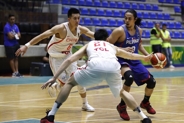 Philippines' Terrence Romeo, right, challenges for the ball against China players Hu Jinqiu, center, and Guo Ailun, left, during the FIBA Asia Cup 2017, at Nouhad Nawfal Sports Complex, in Zouk Mosbeh north of Beirut, Lebanon, Wednesday, Aug. 9, 2017. (AP Photo/Hussein Malla)
