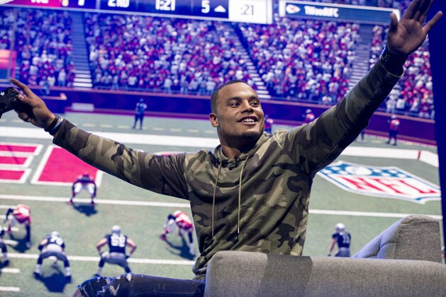 Dallas Cowboys quarterback Dak Prescott plays Madden NFL 17 at the EA Sports Bowl at Club Nomadic on Thursday, Feb. 2, 2017 in Houston. (Photo by Peter Barreras/Invision/AP)