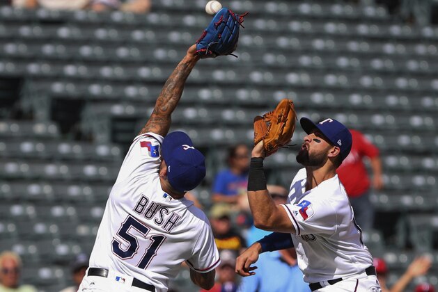 Texas Rangers relief pitcher Matt Bush (51) goes to catch an infield fly ball in front of third baseman Joey Gallo (13) in the eighth inning of a baseball game, Sunday, Aug. 20, 2017, in Arlington, Texas. The play resulted in a collision that caused both players to leave the game. (AP Photo/ Richard W. Rodriguez) Texas Rangers relief pitcher Matt Bush (51) goes to catch an infield fly ball in front of third baseman Joey Gallo (13) in the eighth inning of a baseball game, Sunday, Aug. 20, 2017, in Arlington, Texas. The play resulted in a collision that caused both players to leave the game. (AP Photo/ Richard W. Rodriguez)