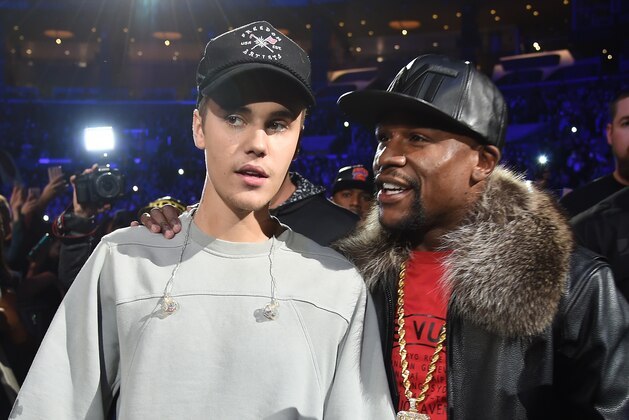 LOS ANGELES, CA - NOVEMBER 13:  Singer/songwriter Justin Bieber (L) and professional boxer Floyd Mayweather Jr. walk backstage during An Evening With Justin Bieber at Staples Center on November 13, 2015 in Los Angeles, California.  (Photo by Jason Merritt/Getty Images for Universal Music)
