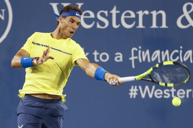 Rafael Nadal, of Spain, returns to Nick Kyrgios, of Australia, at the Western & Southern Open tennis tournament, Friday, Aug. 18, 2017, in Mason, Ohio. (AP Photo/John Minchillo)