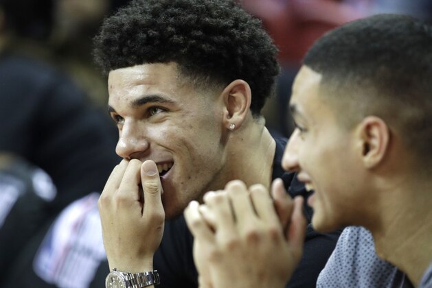 Los Angeles Lakers' Lonzo Ball sits on the bench before an NBA summer league basketball game against the Sacramento Kings, Monday, July 10, 2017, in Las Vegas. (AP Photo/John Locher)