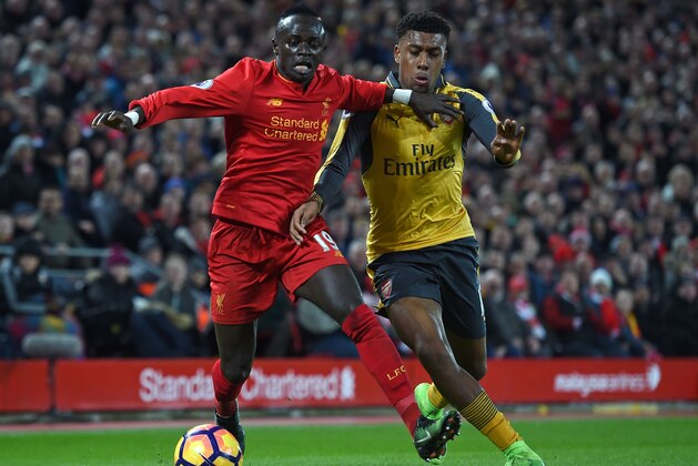 Liverpool's Senegalese midfielder Sadio Mane (L) vies with Arsenal's Nigerian striker Alex Iwobi during the English Premier League football match between Liverpool and Arsenal at Anfield in Liverpool, north west England on March 4, 2017. 
Liverpool won the game 3-1. / AFP PHOTO / Paul ELLIS / RESTRICTED TO EDITORIAL USE. No use with unauthorized audio, video, data, fixture lists, club/league logos or 'live' services. Online in-match use limited to 75 images, no video emulation. No use in betting, games or single club/league/player publications.  /         (Photo credit should read PAUL ELLIS/AFP/Getty Images)
