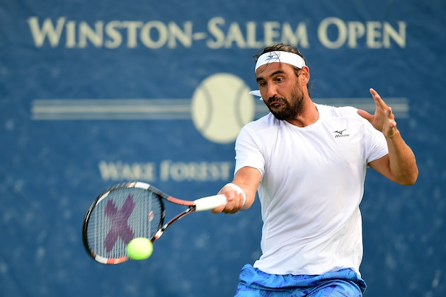 WINSTON SALEM, NC - AUGUST 21:  Marcos Baghdatis of Cyprus returns a shot from Jiri Vesely of Czech Republic during the third day of the Winston-Salem Open at Wake Forest University on August 21, 2017 in Winston Salem, North Carolina.  (Photo by Jared C. Tilton/Getty Images)