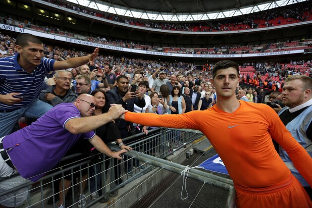 Chelsea's Belgian goalkeeper Thibaut Courtois (R) celebrates victory with supporters after the English Premier League football match between Tottenham Hotspur and Chelsea at Wembley Stadium in London, on August 20, 2017. / AFP PHOTO / Daniel LEAL-OLIVAS / RESTRICTED TO EDITORIAL USE. No use with unauthorized audio, video, data, fixture lists, club/league logos or 'live' services. Online in-match use limited to 75 images, no video emulation. No use in betting, games or single club/league/player publications.  /         (Photo credit should read DANIEL LEAL-OLIVAS/AFP/Getty Images)