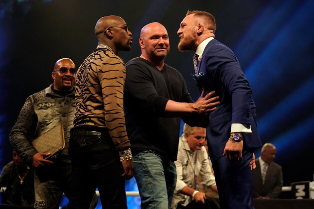 LONDON, ENGLAND - JULY 14:  UFC President Dana White (C) steps between Conor McGregor (R) and Floyd Mayweather Jr. as they face off during the Floyd Mayweather Jr. v Conor McGregor World Press Tour event at SSE Arena on July 14, 2017 in London, England. (Photo by Jeff Bottari/Zuffa LLC/Zuffa LLC via Getty Images)