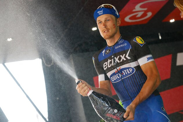 Italy's rider Matteo Trentin celebrates on the podium  after winning the 18th stage of the 99th Giro d'Italia, Tour of Italy, from Muggio to Pinerolo on May 26, 2016. Italy's rider Matteo Trentin won the stage ahead of Italy's Gianluca Brambilla and Italy's Moreno Moser.  AFP PHOTO / LUK BENIES / AFP / LUK BENIES        (Photo credit should read LUK BENIES/AFP/Getty Images)