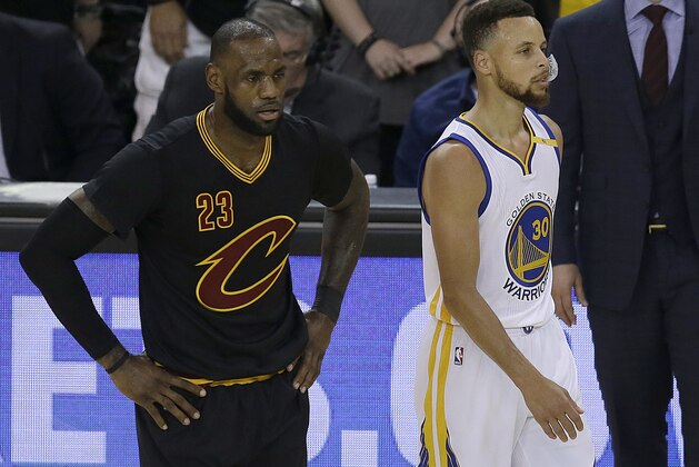 Cleveland Cavaliers forward LeBron James (23) and Golden State Warriors guard Stephen Curry (30) during the first half of Game 5 of basketball's NBA Finals in Oakland, Calif., Monday, June 12, 2017. (AP Photo/Ben Margot)