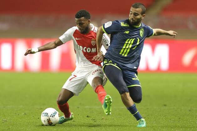 Monaco's Thomas Lemar, left, challenges for the ball with Lille's Naim Sliti during a League One soccer match between Monaco and Lille, at the Louis II stadium, in Monaco, Sunday, May, 14 2017. (AP Photo/Claude Paris)