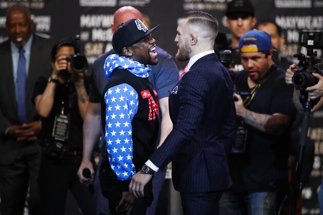 Floyd Mayweather Jr., left, and Conor McGregor exchange words during a news conference at Staples Center on Tuesday, July 11, 2017, in Los Angeles. The two will fight in a boxing match in Las Vegas on Aug. 26. (AP Photo/Jae C. Hong)