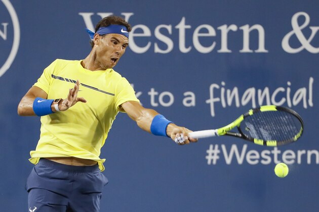 Rafael Nadal, of Spain, returns to Nick Kyrgios, of Australia, at the Western & Southern Open tennis tournament, Friday, Aug. 18, 2017, in Mason, Ohio. (AP Photo/John Minchillo)