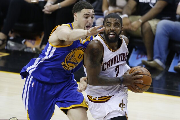 Cleveland Cavaliers guard Kyrie Irving (2) drives on Golden State Warriors guard Klay Thompson (11) during the first half of Game 4 of basketball's NBA Finals in Cleveland, Friday, June 9, 2017. (AP Photo/Ron Schwane)