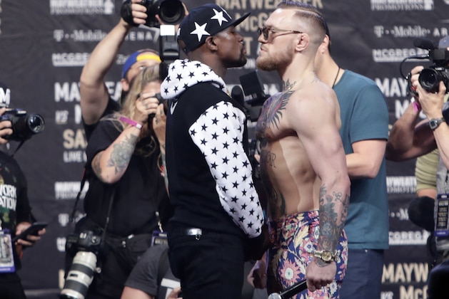 In this July 13, 2017, file photo, Floyd Mayweather Jr., left, and Conor McGregor, of Ireland, face each other for photos during a news conference at Barclays Center in New York. Nevada boxing regulators went out of their way to give a gift to both fighters, approving an exemption to the rule requiring 10-ounce gloves for the 154-pound fight so that both fighters can wear 8-ounce gloves. And just like that, the fight appeared more competitive–at least to some. (AP Photo/Frank Franklin II, File) In this July 13, 2017, file photo, Floyd Mayweather Jr., left, and Conor McGregor, of Ireland, face each other for photos during a news conference at Barclays Center in New York. Nevada boxing regulators went out of their way to give a gift to both fighters, approving an exemption to the rule requiring 10-ounce gloves for the 154-pound fight so that both fighters can wear 8-ounce gloves. And just like that, the fight appeared more competitive–at least to some. (AP Photo/Frank Franklin II, File)