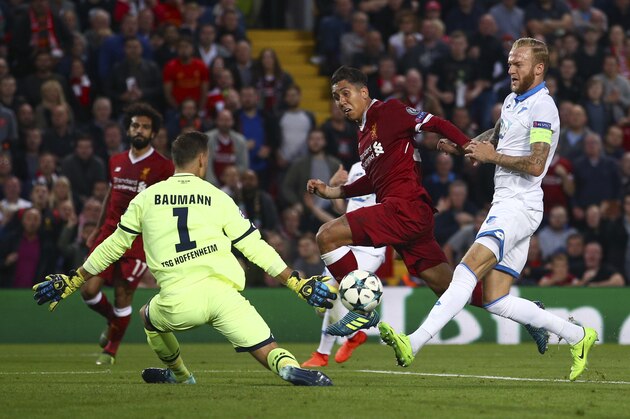 Liverpool's Roberto Firmino, centre, has a goal attempt saved by Hoffenheim's goalkeeper Oliver Baumann during the Champions League qualifying play-off second leg soccer match between Liverpool and Hoffenheim at Anfield stadium in Liverpool, England, Wednesday, Aug. 23, 2017. (AP Photo/Dave Thompson)