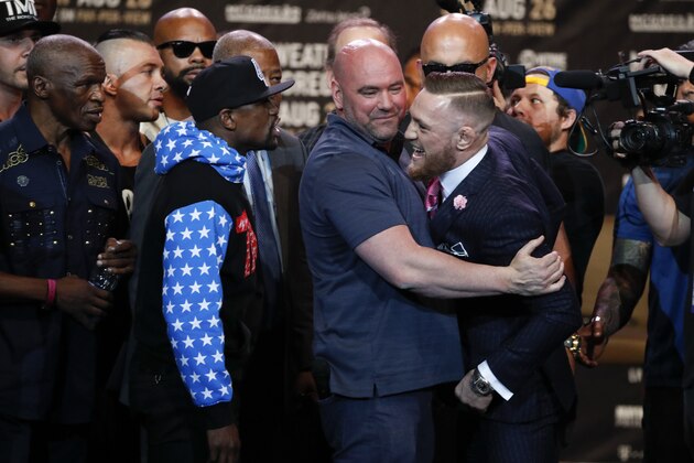 UFC president Dana White, center, intervenes as Floyd Mayweather Jr., left, and Conor McGregor exchange words during a news conference at Staples Center Tuesday, July 11, 2017, in Los Angeles. The two will fight in a boxing match in Las Vegas on Aug. 26. (AP Photo/Jae C. Hong)