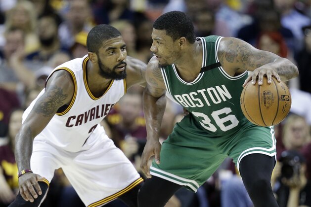 Boston Celtics' Marcus Smart (36) looks to drive on Cleveland Cavaliers' Kyrie Irving (2) during the second half of Game 3 of the NBA basketball Eastern Conference finals, Sunday, May 21, 2017, in Cleveland. (AP Photo/Tony Dejak)