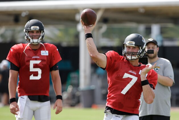 Jacksonville Jaguars quarterback Blake Bortles (5) looks on as quarterback Chad Henne (7) throws a pass during practice at NFL football training camp, Wednesday, Aug. 5, 2015, in Jacksonville, Fla. (AP Photo/John Raoux)