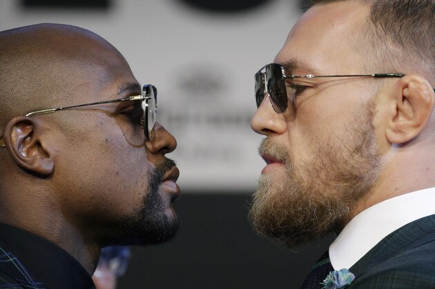 Floyd Mayweather Jr., left, and Conor McGregor pose for photographers during a news conference Wednesday, Aug. 23, 2017, in Las Vegas. The two are scheduled to fight in a boxing match Saturday in Las Vegas. (AP Photo/John Locher)