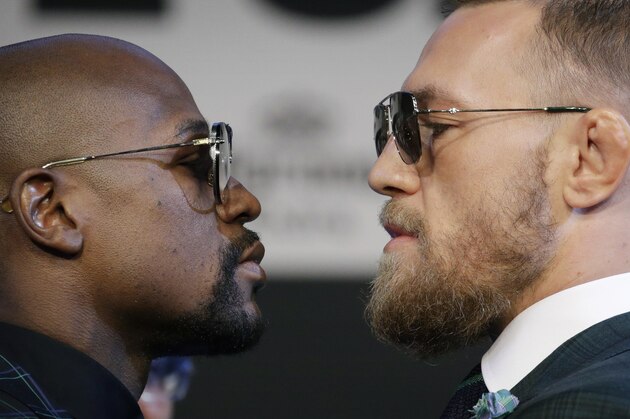 Floyd Mayweather Jr., left, and Conor McGregor pose for photographers during a news conference Wednesday, Aug. 23, 2017, in Las Vegas. The two are scheduled to fight in a boxing match Saturday in Las Vegas. (AP Photo/John Locher)