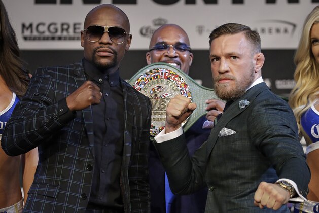 Floyd Mayweather Jr., left, and Conor McGregor pose for photographers during a news conference Wednesday, Aug. 23, 2017, in Las Vegas. The two are scheduled to fight in a boxing match Saturday in Las Vegas. (AP Photo/John Locher)