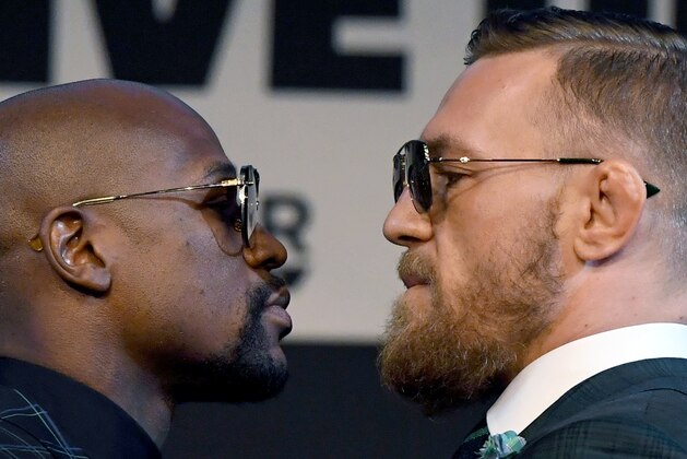 LAS VEGAS, NV - AUGUST 23:  Boxer Floyd Mayweather Jr. (L) and UFC lightweight champion Conor McGregor face off during a news conference at the KA Theatre at MGM Grand Hotel & Casino on August 23, 2017 in Las Vegas, Nevada. The two will meet in a super welterweight boxing match at T-Mobile Arena on August 26 in Las Vegas.  (Photo by Ethan Miller/Getty Images)