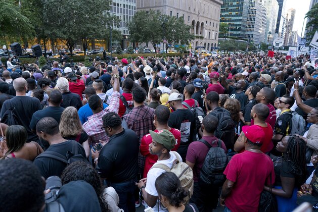 People gather in support of unsigned NFL quarterback Colin Kaepernick on Wednesday, Aug. 23, 2017, in front of NFL headquarters in New York. (AP Photo/Craig Ruttle)