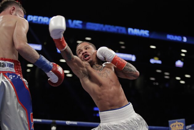 Gervonta Davis, right, fights Jose Pedraza, of Puerto Rico, during the third round of a junior lightweight title fight  Saturday, Jan. 14, 2017, at Barclays Center in New York. Davis stopped Pedraza in the seventh round.(AP Photo/Frank Franklin II)