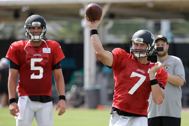 Jacksonville Jaguars quarterback Blake Bortles (5) looks on as quarterback Chad Henne (7) throws a pass during practice at NFL football training camp, Wednesday, Aug. 5, 2015, in Jacksonville, Fla. (AP Photo/John Raoux)