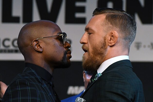 LAS VEGAS, NV - AUGUST 23:  Boxer Floyd Mayweather Jr. (L) and UFC lightweight champion Conor McGregor face off during a news conference at the KA Theatre at MGM Grand Hotel & Casino on August 23, 2017 in Las Vegas, Nevada. The two will meet in a super welterweight boxing match at T-Mobile Arena on August 26 in Las Vegas.  (Photo by Ethan Miller/Getty Images)