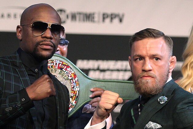 Boxer Floyd Mayweather Jr. (L) and MMA figher Connor Mcgregor pose during a media press conference August 23, 2017 at the MGM Grand in Las Vegas, Nevada. 
Mayweather, the 40-year-old undefeated former welterweight boxing champion, has been lured out of retirement to face McGregor, a star of mixed martial arts' Ultimate Fighting Championship. The two men meet in a 12-round contest under boxing rules on August 26th that is tipped to become the richest fight in history.
 / AFP PHOTO / John Gurzinski        (Photo credit should read JOHN GURZINSKI/AFP/Getty Images)