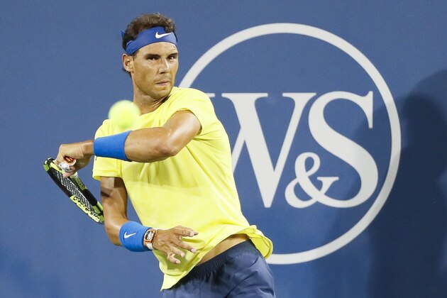 Rafael Nadal, of Spain, returns to Nick Kyrgios, of Australia, at the Western & Southern Open tennis tournament, Friday, Aug. 18, 2017, in Mason, Ohio. (AP Photo/John Minchillo)