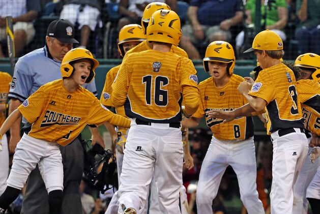 Greenville, N.C.'s Carson Hardee (16) is greeted by teammates after hitting a solo home run off Lufkin, Texas, pitcher Hunter Ditsworth during the first inning of a Little League World Series baseball game in South Williamsport, Pa., Wednesday, Aug. 23, 2017. North Carolina won in seven innings, 2-1. (AP Photo/Gene J. Puskar)
