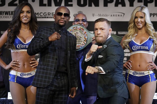 Floyd Mayweather Jr., left, and Conor McGregor pose for photographers during a news conference Wednesday, Aug. 23, 2017, in Las Vegas. The two are scheduled to fight in a boxing match Saturday in Las Vegas. (AP Photo/John Locher)