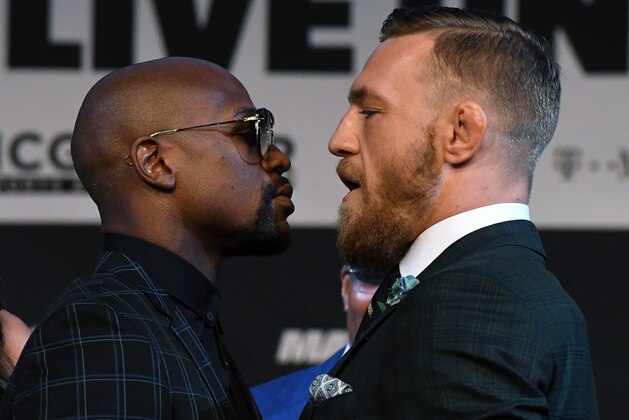 LAS VEGAS, NV - AUGUST 23: Boxer Floyd Mayweather Jr. (L) and UFC lightweight champion Conor McGregor face off during a news conference at the KA Theatre at MGM Grand Hotel & Casino on August 23, 2017 in Las Vegas, Nevada. The two will meet in a super welterweight boxing match at T-Mobile Arena on August 26 in Las Vegas. (Photo by Ethan Miller/Getty Images) LAS VEGAS, NV - AUGUST 23: Boxer Floyd Mayweather Jr. (L) and UFC lightweight champion Conor McGregor face off during a news conference at the KA Theatre at MGM Grand Hotel & Casino on August 23, 2017 in Las Vegas, Nevada. The two will meet in a super welterweight boxing match at T-Mobile Arena on August 26 in Las Vegas. (Photo by Ethan Miller/Getty Images)
