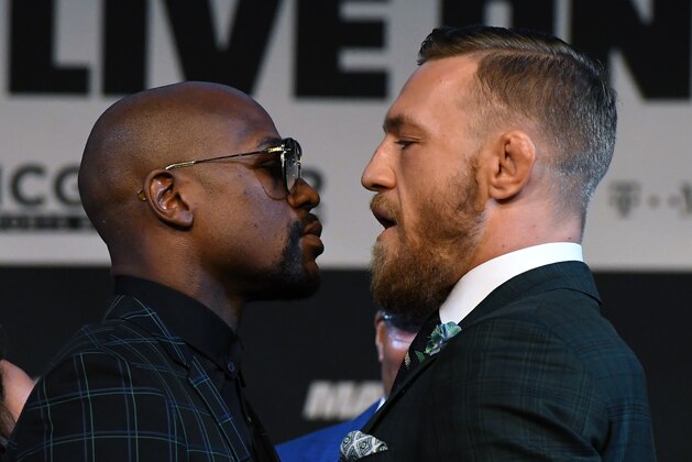 LAS VEGAS, NV - AUGUST 23:  Boxer Floyd Mayweather Jr. (L) and UFC lightweight champion Conor McGregor face off during a news conference at the KA Theatre at MGM Grand Hotel & Casino on August 23, 2017 in Las Vegas, Nevada. The two will meet in a super welterweight boxing match at T-Mobile Arena on August 26 in Las Vegas.  (Photo by Ethan Miller/Getty Images)