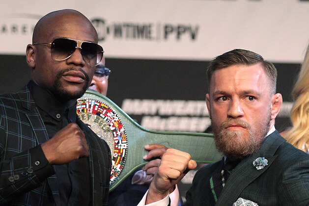Boxer Floyd Mayweather Jr. (L) and MMA figher Connor Mcgregor pose during a media press conference August 23, 2017 at the MGM Grand in Las Vegas, Nevada. 
Mayweather, the 40-year-old undefeated former welterweight boxing champion, has been lured out of retirement to face McGregor, a star of mixed martial arts' Ultimate Fighting Championship. The two men meet in a 12-round contest under boxing rules on August 26th that is tipped to become the richest fight in history.
 / AFP PHOTO / John Gurzinski        (Photo credit should read JOHN GURZINSKI/AFP/Getty Images)