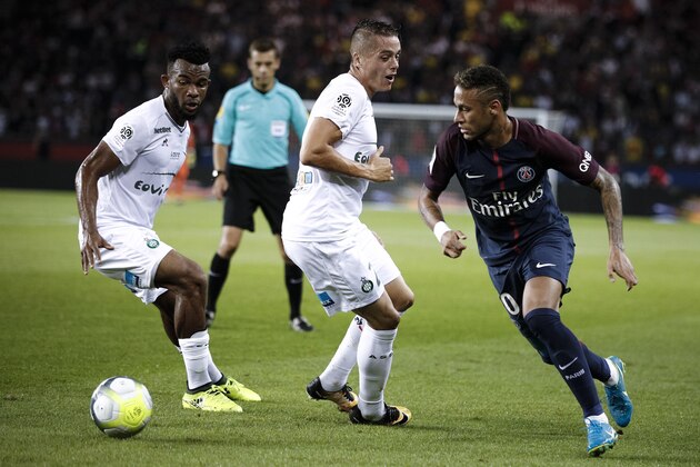 PSG's Neymar, right,  dribbles Saint Etienne's Habib Maiga, left, during the French League One soccer match between Paris Saint Germain and Saint Etienne at the Parc des Princes stadium in Paris, France, Friday, Aug. 25, 2017. (AP Photo/Kamil Zihnioglu)