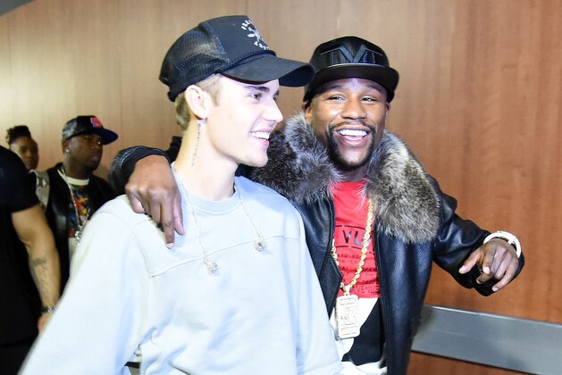 LOS ANGELES, CA - NOVEMBER 13:  Singer/songwriter Justin Bieber (L) and professional boxer Floyd Mayweather Jr. walk backstage during An Evening With Justin Bieber at Staples Center on November 13, 2015 in Los Angeles, California.  (Photo by Jason Merritt/Getty Images for Universal Music)