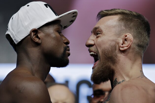 Floyd Mayweather Jr., left, and Conor McGregor face off during a weigh-in Friday, Aug. 25, 2017, in Las Vegas. The two are scheduled to fight in a boxing match Saturday in Las Vegas. (AP Photo/John Locher)